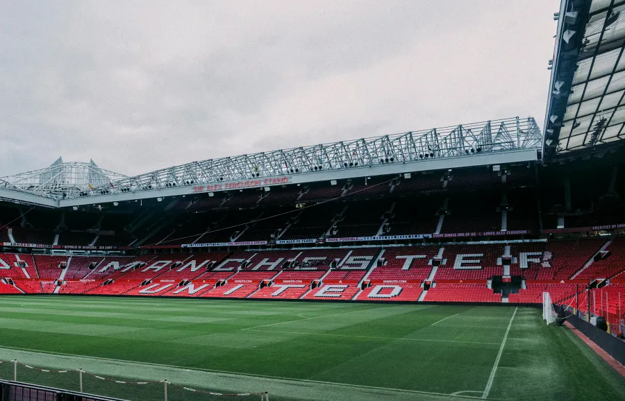 The pitch and red stands at Old Trafford, Manchester
